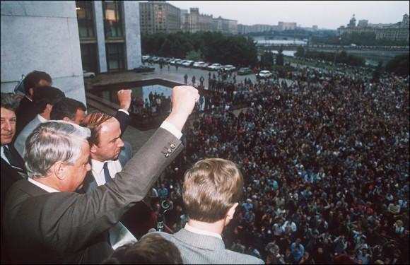 A defiant Russian President Boris Yeltsin (L) clenches a fist to his supporters from the Russian Federation building 19 August 1991 in Moscow calling on them for a general strike and to resist the pro-communist coup against Soviet President Gorbachev.<br/>(Dima Tanin/AFP/Getty Images)