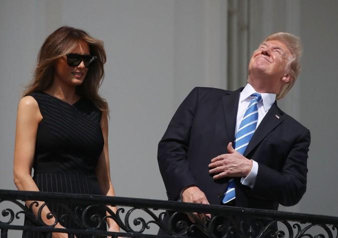 President Donald Trump looks up toward the solar eclipse, joined by his wife first lady Melania Trump on the Truman Balcony at the White House on Aug. 21, 2017. Millions of people have flocked to areas of the United States that are in the path of totality in order to experience a total solar eclipse. (Mark Wilson/Getty Images)