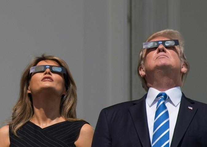 President Donald Trump and first lady Melania Trump look up at the partial solar eclipse from the balcony of the White House, on Aug. 21, 2017. (Nicholas Kamm/AFP/Getty Images)