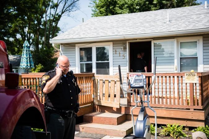 Law enforcement officials at the home of a man who was found dead from an apparent drug overdose in Drexel, Montgomery County, Ohio, on Aug. 3, 2017. (Benjamin Chasteen/The Epoch Times)