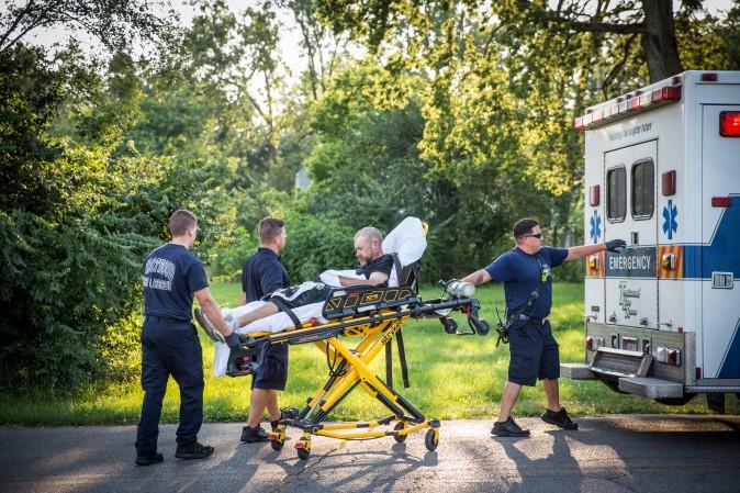 Paramedics assist a man who has just been administered a dose of Narcan for an apparent opioid overdose in Montgomery County, Ohio, on Aug. 3, 2017. (Benjamin Chasteen/The Epoch Times)