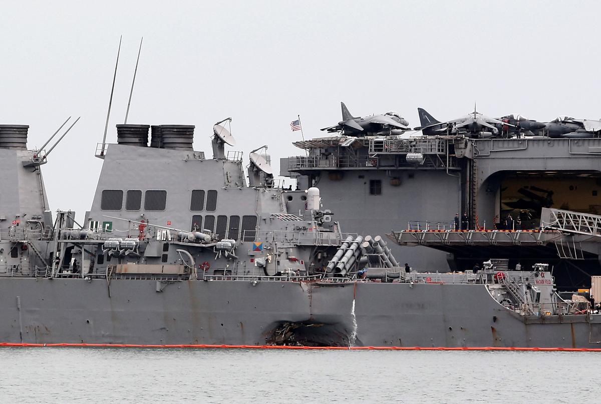 The damaged USS John McCain is docked next to USS America at Changi Naval Base in Singapore on August 22, 2017. (REUTERS/Calvin Wong)
