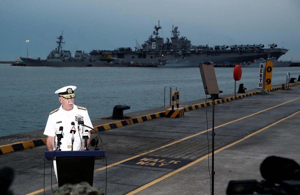 Admiral Scott Swift, Commander of the U.S. Pacific Fleet, speaks at a news conference near the damaged USS John McCain and the USS America at Changi Naval Base in Singapore on August 22, 2017. (REUTERS/Calvin Wong)