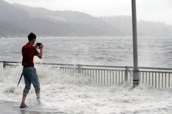 A man takes photo after Typhoon Hato hits Hong Kong, China August 23, 2017. (Reuters/Tyrone Siu)