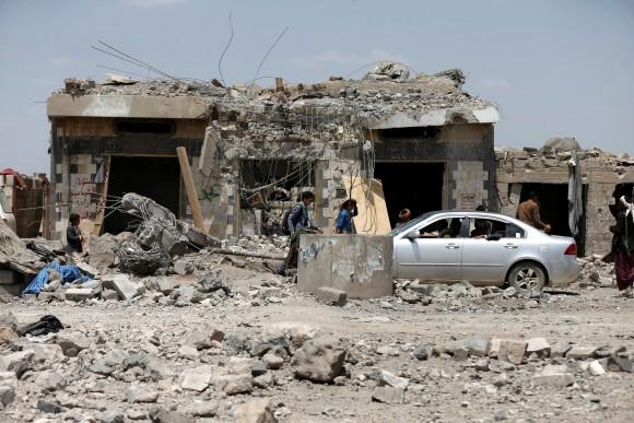 People walk at the site of Saudi-led air strikes in Arhab area, around 20 kilometres (13 miles) north of Sanaa, Yemen August 23, 2017. (Reuters/Khaled Abdullah)