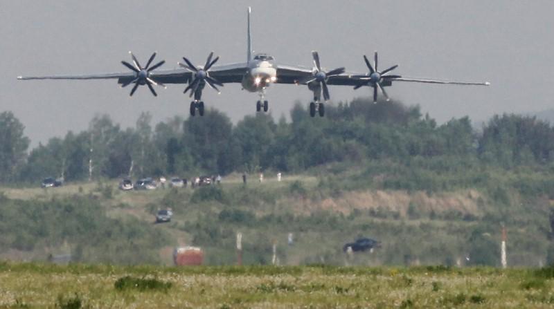 A Tupolev Tu-95MS strategic bomber, the carrier of nuclear rockets, lands at the Yemelyanovo airport near Russia's Siberian city of Krasnoyarsk on June 8, 2011. (REUTERS/Ilya Naymushin)