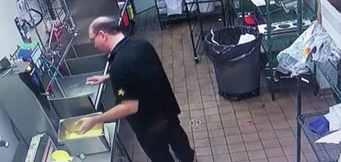 Jack Webb, the co-franchisee of a Carl's Jr. in Alberta, Canada, can be seen mixing what looks like batter with his bare hands. (Screenshot via CBC/Youtube)