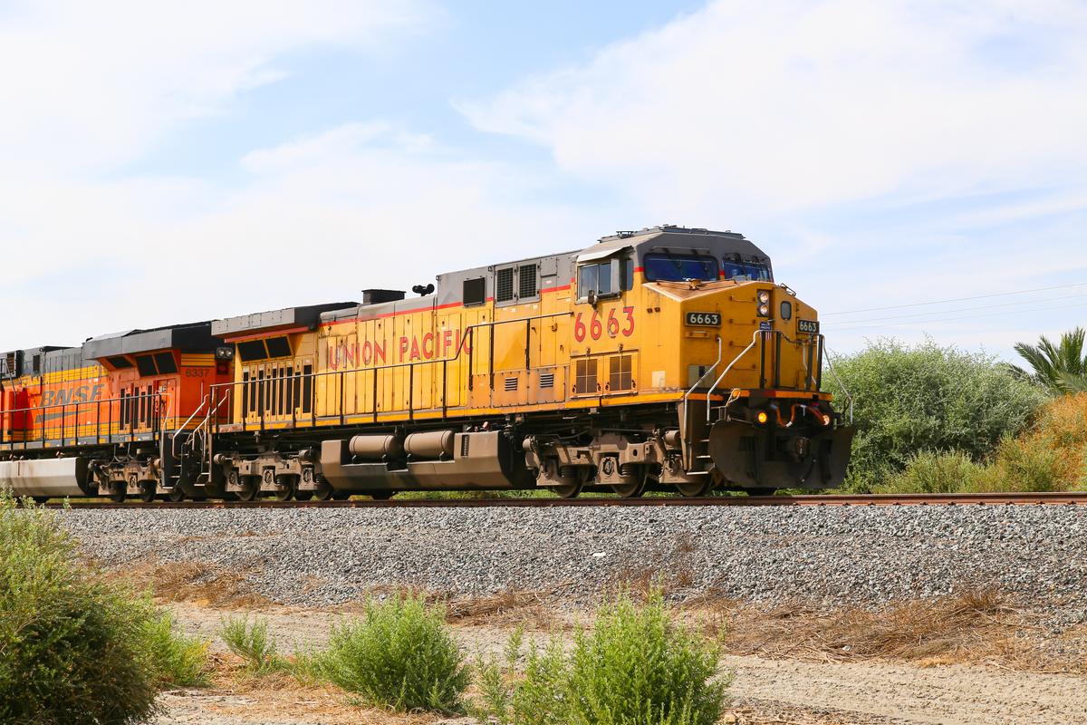 Freight train with both Union Pacific and BNSF engines on track next to California State Route 111. (Michael Rosebrock/Shutterstock)