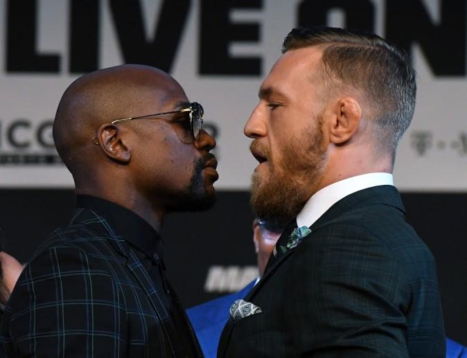 Boxer Floyd Mayweather Jr. (L) and UFC lightweight champion Conor McGregor face off during a news conference at the KA Theatre at MGM Grand Hotel & Casino in Las Vegas, Nevada on Aug. 23, 2017. The two will meet in a super welterweight boxing match at T-Mobile Arena on Aug. 26 in Las Vegas. (Ethan Miller/Getty Images)