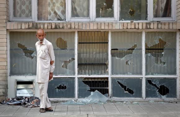 A man surveys the damage after a day of violence in Panchkula, India August 26, 2017. (Reuters/Cathal McNaughton)