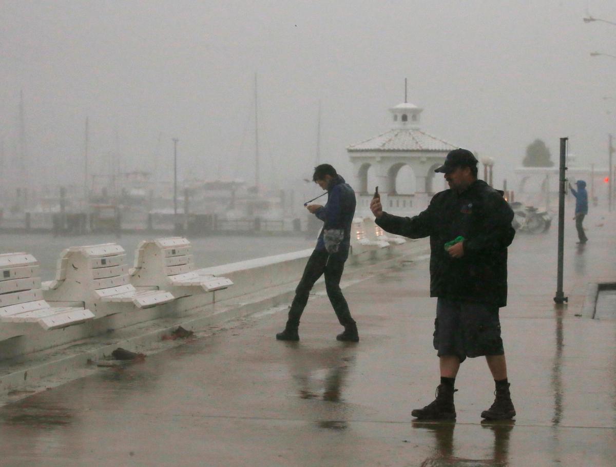 A storm chaser films himself on a camera phone as Hurricane Harvey approaches, on the boardwalk in Corpus Christi, Texas. (REUTERS/Adrees Latif)