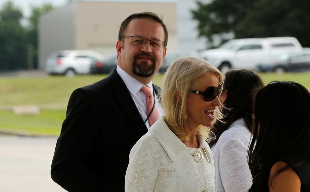 White House adviser Sebastian Gorka (L), standing with White House counselor Kellyanne Conway (C), waits for U.S. President Donald Trump to arrive to board Air Force One for travel to Ohio from Joint Base Andrews, Maryland on July 25, 2017. (REUTERS/Jonathan Ernst)