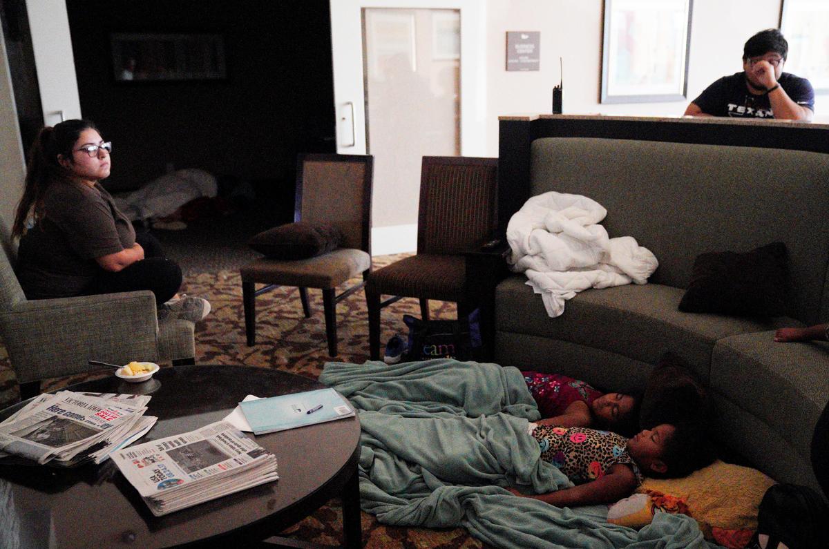 Children sleep in a hotel lobby waiting out Hurricane Harvey in Victoria, Texas on Aug. 26, 2017. (REUTERS/Rick Wilking)
