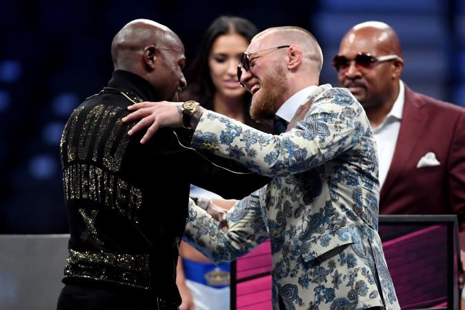 (L-R) Floyd Mayweather Jr. and Conor McGregor shake hands after Mayweather's 10th round TKO victory in their super welterweight boxing match at T-Mobile Arena in Las Vegas, Nevada on Aug. 26, 2017. (Ethan Miller/Getty Images)