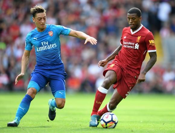 Mesut Ozil of Arsenal and Georginio Wijnaldum of Liverpool battle for possession during the Premier League match between Liverpool and Arsenal at Anfield on August 27, 2017 in Liverpool, England. (Michael Regan/Getty Images)