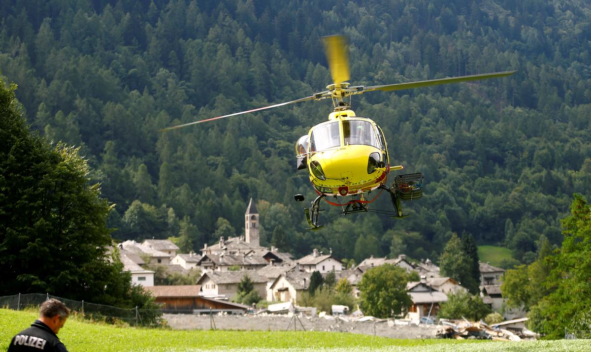 A helicopter of HeliBernina takes off nearby the village of Bondo in Switzerland, on Aug. 26, 2017. (REUTERS/Arnd Wiegmann)