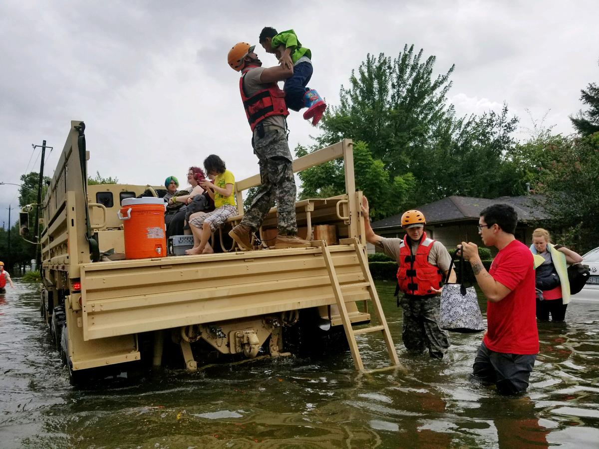Texas National Guard soldiers aid residents in heavily flooded areas from the storms of Hurricane Harvey in Houston, Texas, U.S. on Aug. 27, 2017 (100th MPAD/Texas Military Department/Handout via REUTERS)