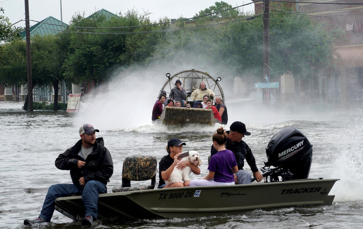 People are rescued from flood waters from Hurricane Harvey on an air boat in Dickinson, Texas on Aug. 27, 2017. (REUTERS/Rick Wilking)