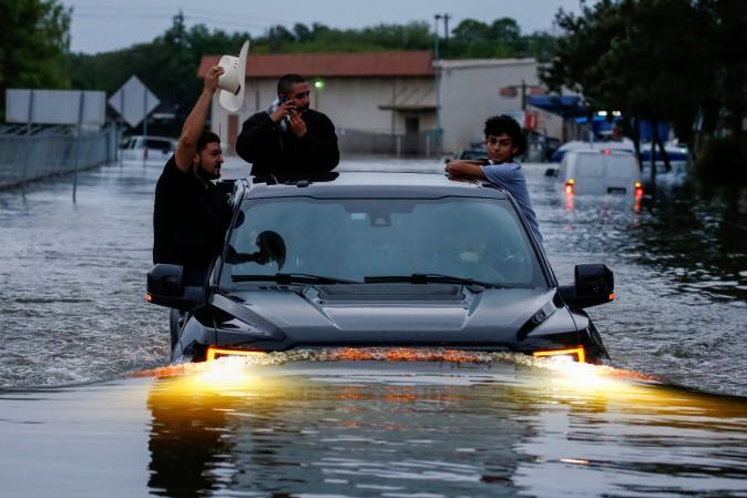 Residents use a truck to navigate through floodwaters from Tropical Storm Harvey in Houston, Texas,  Aug. 27, 2017. (Adrees Latif/Reuters)