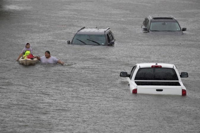 Jesus Rodriguez rescues Gloria Garcia in Pearland, in the outskirts of Houston. (REUTERS/Adrees Latif)