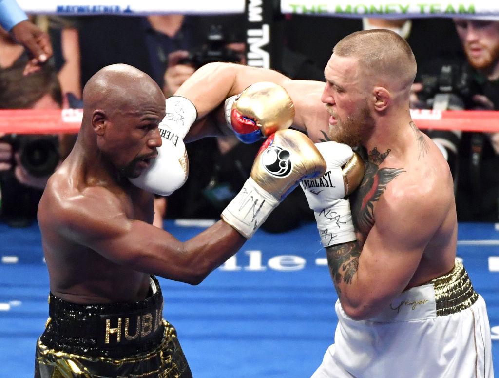 Floyd Mayweather (L) and Jr. Conor McGregor battle in the sixth round of their super welterweight boxing match at T-Mobile Arena on August 26, 2017 in Las Vegas, Nevada. (Ethan Miller/Getty Images)