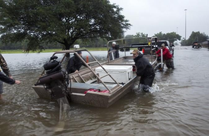 Volunteer search and rescuers from Passion Pursuit film production company launch their motor boat near Bray Bayou and Loop 610 to rescue flood victims in the Meyerland neighborhood after Hurricane Harvey inundated the area Aug. 28, 2017 in Houston, Texas. (Erich Schlegel/Getty Images)