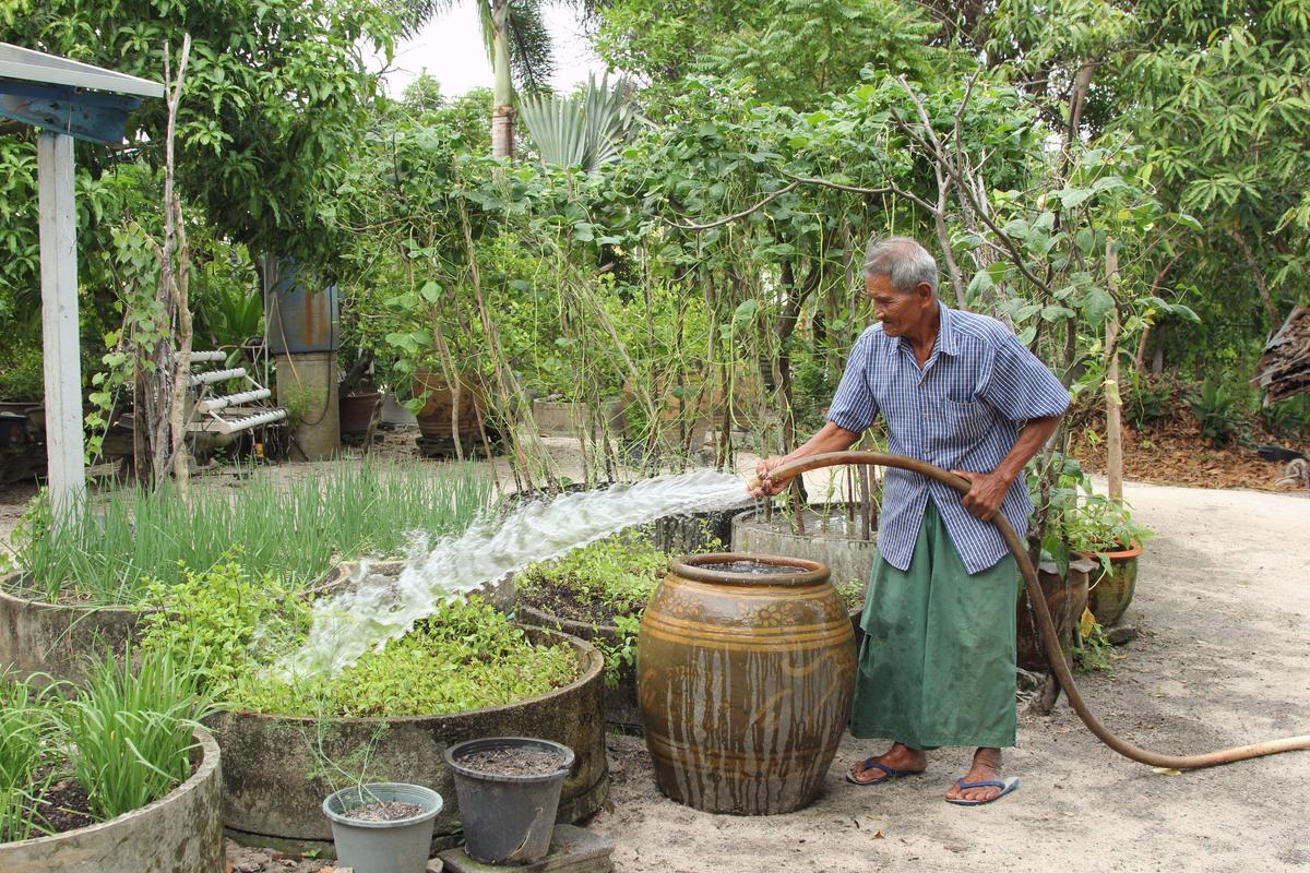  Noi Jaitang waters his garden in Map Ta Phut, Thailand, where the World Resources Institute has been working to address problems with water pollution. (Laura Villadiego)
