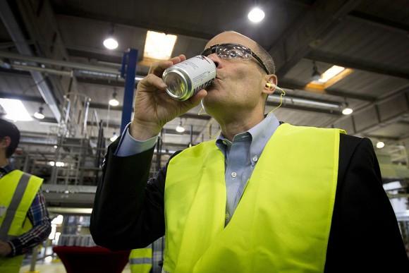 Carlos Brito, CEO of brewery group AB Inbev, drinks a can of 'emergency water' during the launch of new 'emergency drinking water cans', which would be made available for people during disasters in Western Europe, in Leuven, on June 5, 2013. (KRISTOF VAN ACCOM/AFP/Getty Images)