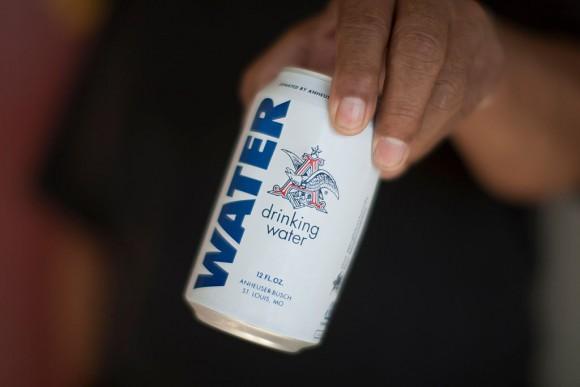 A resident holds a can of water donated by the Anheuser-Busch company as water wells supplying hundreds of residents remain dry in the fourth year of worsening drought on Feb. 11, 2015, in East Porterville, Calif. (David McNew/Getty Images)
