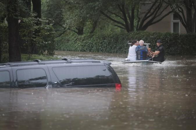 Volunteers and officers from the neighborhood security patrol help to rescue residents in the upscale River Oaks neighborhood after it was inundated with flooding from Hurricane Harvey on Aug. 27, 2017 in Houston, Texas. (Scott Olson/Getty Images)