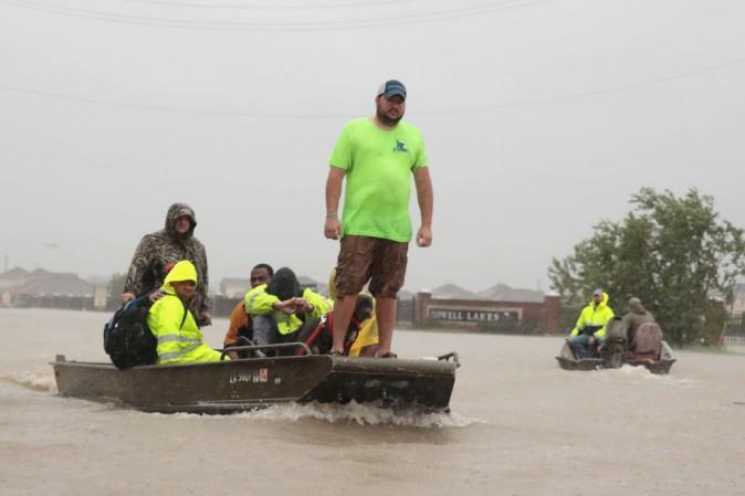 People are rescued from a flooded neighborhood after it was inundated with rain water, remnants of Hurricane Harvey, on Aug. 28, 2017, in Houston, Texas. Harvey, which made landfall north of Corpus Christi late Friday evening, is expected to dump upward of 40 inches of rain in areas of Texas over the next couple of days. (Scott Olson/Getty Images)