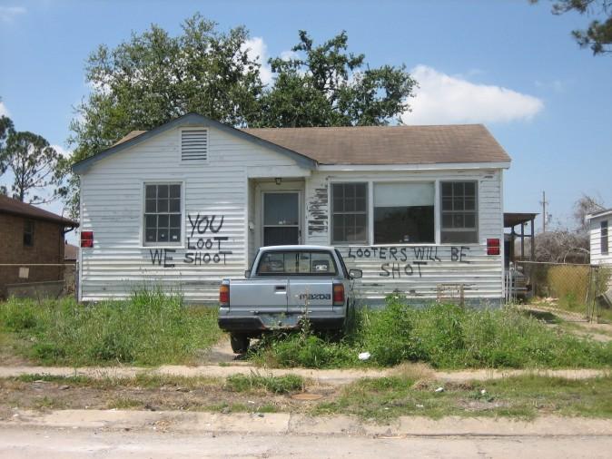 A house in formerly flooded neighborhood of Eastern New Orleans in 2005 warns looters of potentially deadly consequences. (Infrogmation/Wikimedia Commons)