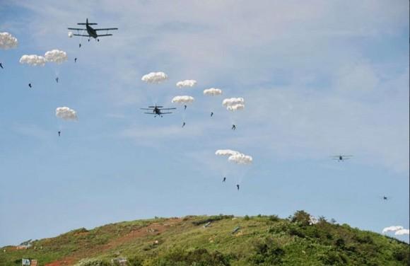 Antonov An-2 airplanes drop paratroopers during a military exercise. (North Korean State Media)