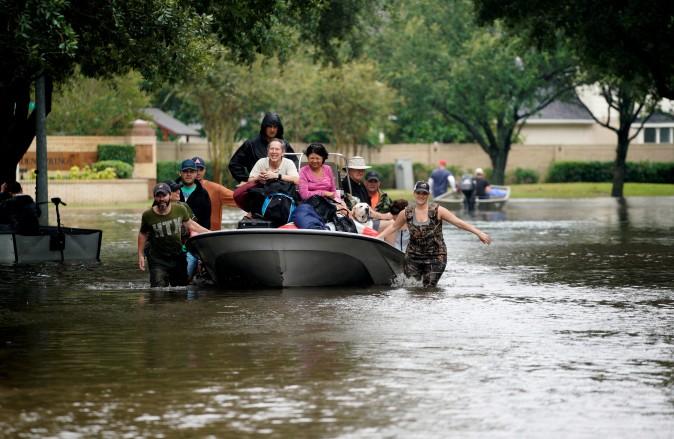 People evacuate by boat from the Hurricane Harvey floodwaters in Houston, Texas Aug. 29, 2017. (Reuters/Rick Wilking)