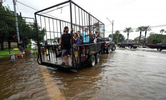 A group of people are shuttled to dry ground in a trailer after being evacuated by boat from the Hurricane Harvey floodwaters in Houston, Texas August 29, 2017. (Reuters/Rick Wilking)