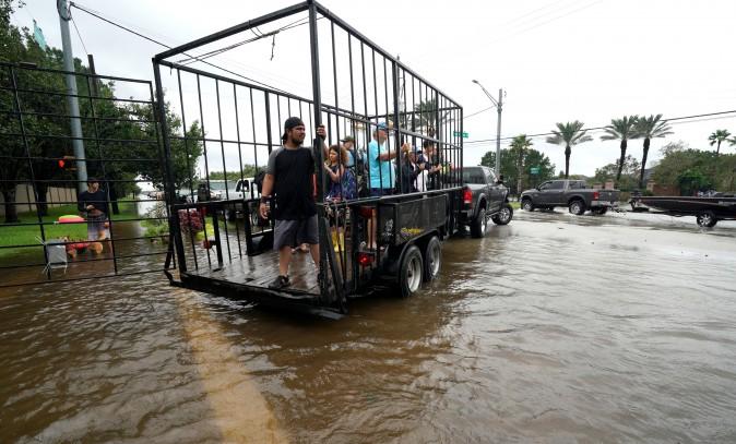 A group of people are shuttled to dry ground in a trailer after being evacuated by boat from the Hurricane Harvey floodwaters in Houston, Texas, Aug. 29, 2017. (Rick Wilking/Reuters)