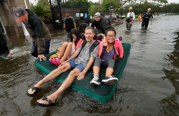 A family is evacuated on an air mattress from the Hurricane Harvey floodwaters in Houston, Texas August 29, 2017. (Reuters/Rick Wilking)