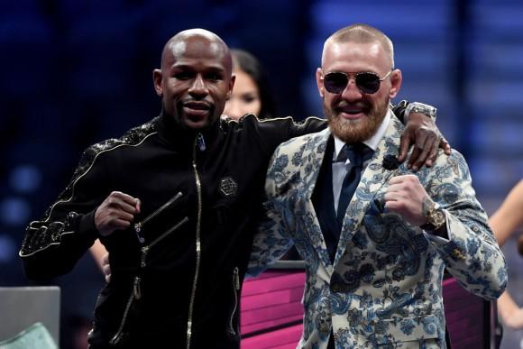 Floyd Mayweather Jr. (L) and Conor McGregor pose for pictures during a news conference after Mayweather's 10th-round TKO victory in their super welterweight boxing match on Aug. 26, 2017, at T-Mobile Arena in Las Vegas, Nev. (Ethan Miller/Getty Images)