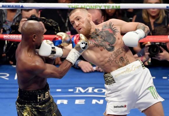 Conor McGregor (R) throws a right at Floyd Mayweather Jr. in the second round of their super welterweight boxing match at T-Mobile Arena on Aug. 26, 2017, in Las Vegas, Nev. (Ethan Miller/Getty Images)