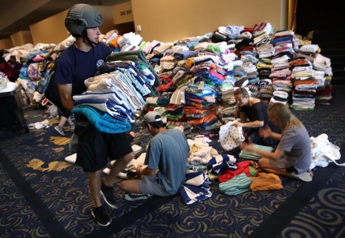 Volunteers organize donated emergency supplies at the temporary shelter at the Lakewood Church August 29, 2017 in Houston, Texas. Thousands of Houston area residents are currently residing in shelters due to flooding caused by the impact of Hurricane Harvey. (Win McNamee/Getty Images)