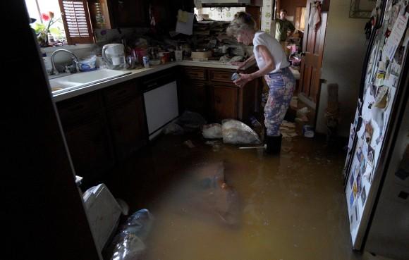 Nancy McBride collects items from her flooded kitchen as she returned to her home for the first time since Harvey floodwaters arrived in Houston, Texas, Sept. 1, 2017. (Rick Wilking/Reuters)
