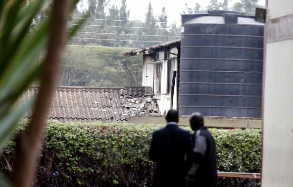 Investigators stand inside a cordon line following a fire that burnt down one dormitory of Moi Girls school in Nairobi, Kenya September 2, 2017. (Reuters/Baz Ratner)