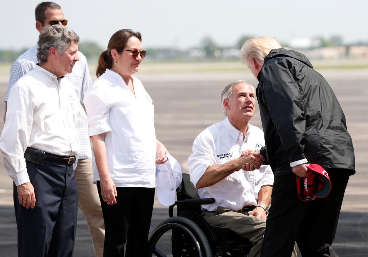 U.S. President Donald Trump greets Texas Governor Greg Abbott after arriving at Ellington Field to meet with flood survivors and volunteers who assisted in relief efforts in the aftermath of Hurricane Harvey in Houston on September 2, 2017. (REUTERS/Kevin Lamarque)