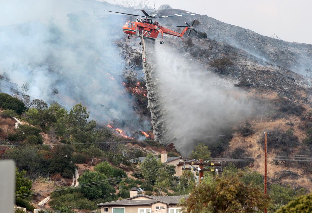 Water is dropped above homes in Sun Valley during the La Tuna Canyon fire over Burbank. (REUTERS/ Kyle Grillot)