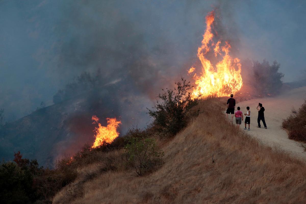 People look on at the La Tuna Canyon fire over Burbank. (REUTERS/Kyle Grillot)