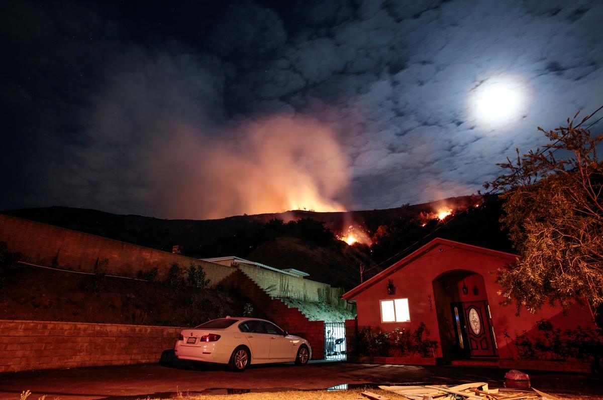 Flames rise over Sun Valley homes during the La Tuna Canyon fire over Burbank. (REUTERS/ Kyle Grillot)