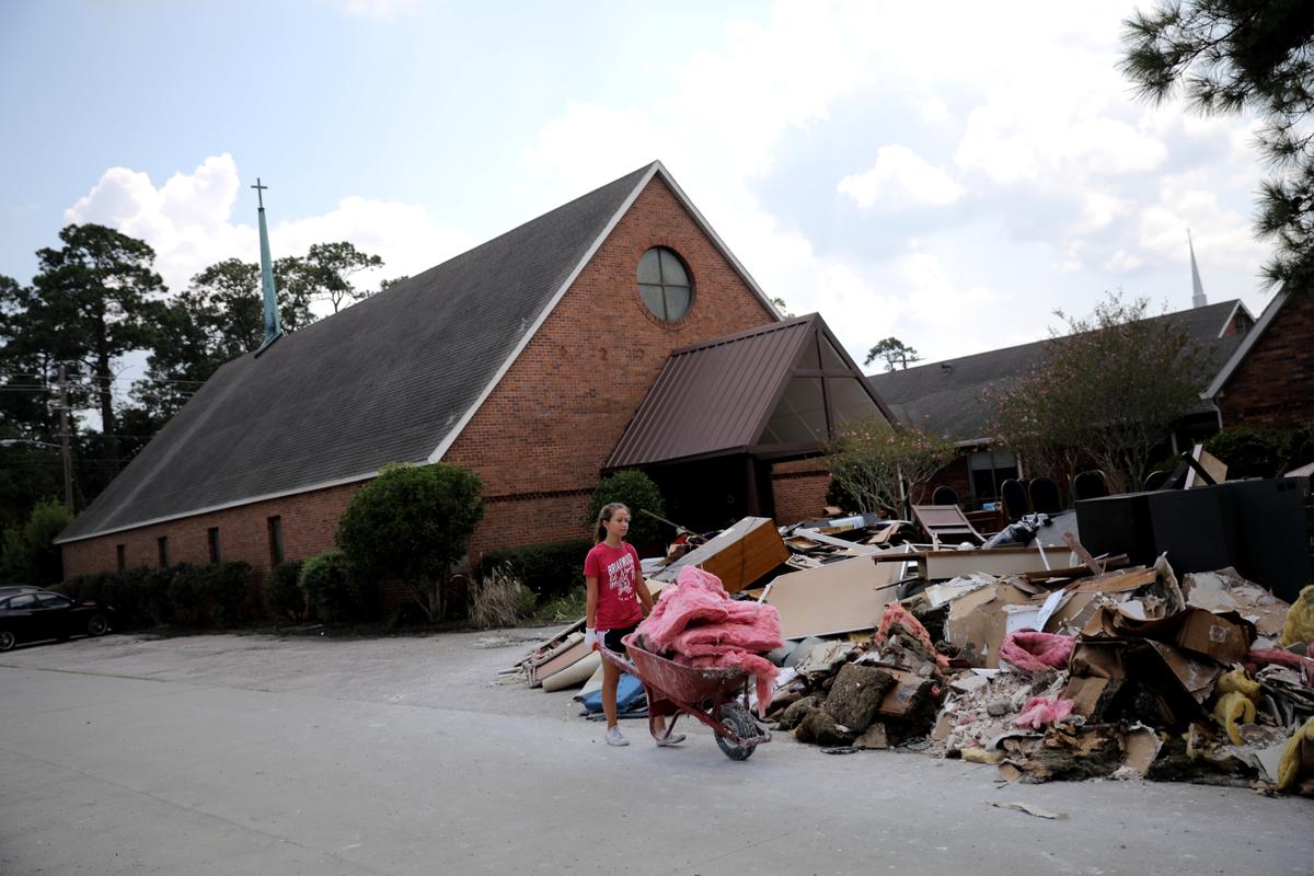 A volunteer helps clean up the damage at a Lutheran church in Dickinson, Texas. (REUTERS/Carlos Barria)
