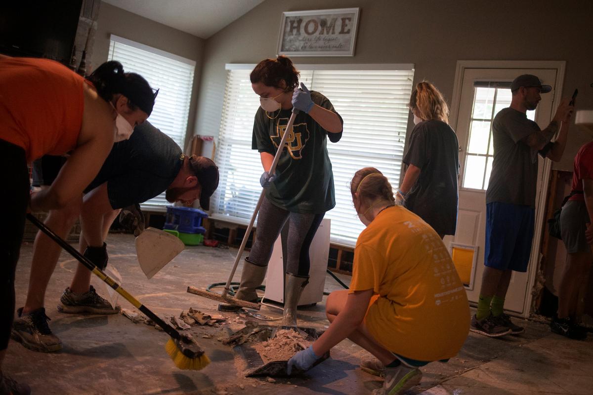 Samaritans help clear debris from the house of a neighbor which was left flooded from Tropical Storm Harvey in Houston, Texas on Sept. 3, 2017. (REUTERS/Adrees Latif)