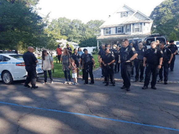 New York police officers from a precinct in the Bronx accompany Austin, son of slain Sgt. Paul Tuozzolo, to his first day of school. (NYPD/Twitter)