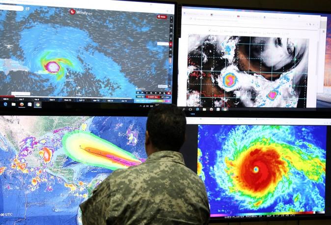 A member of the Emergency Operations Committee (COE) monitors the trajectory of Hurricane Irma in Santo Domingo, the Dominican Republic on Sept. 5, 2017. (Reuters/Ricardo Rojas)